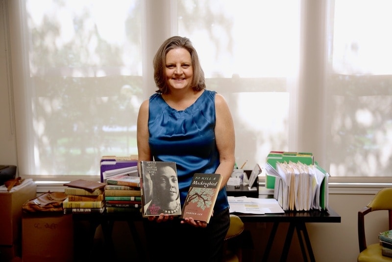 Communication professor Lynn Caldwell displays two rare books that are part of her collection. [PHOTO: Natan Vigna]